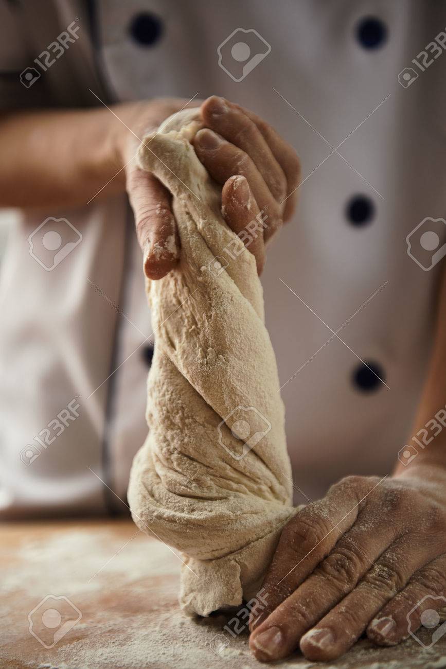 Close-up of female chef hands kneading the dough on the board. Bread preparation. - 55392650 Close-up of female chef hands kneading the dough on the board. Bread preparation. - 55392650