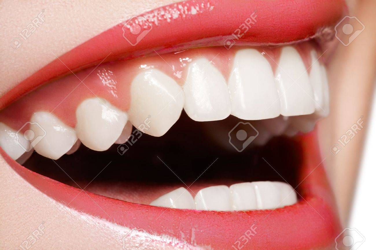 Macro happy woman's smile with healthy white teeth, bright red gloss lips make-up. Stomatology and beauty care - 11713883 Macro happy woman's smile with healthy white teeth, bright red gloss lips make-up. Stomatology and beauty care - 11713883