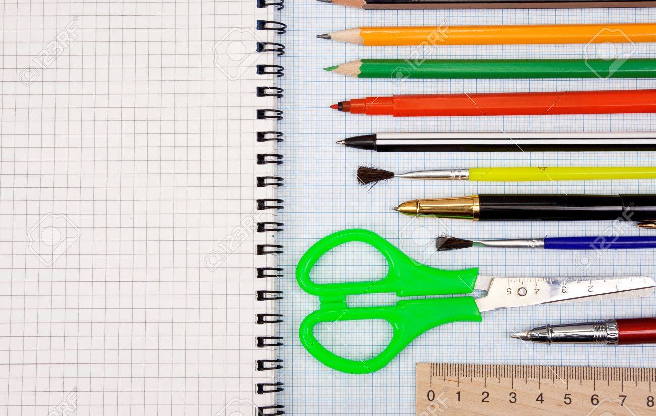 pens pencils paint brush and scissors on graph grid paper stock paint graph paper