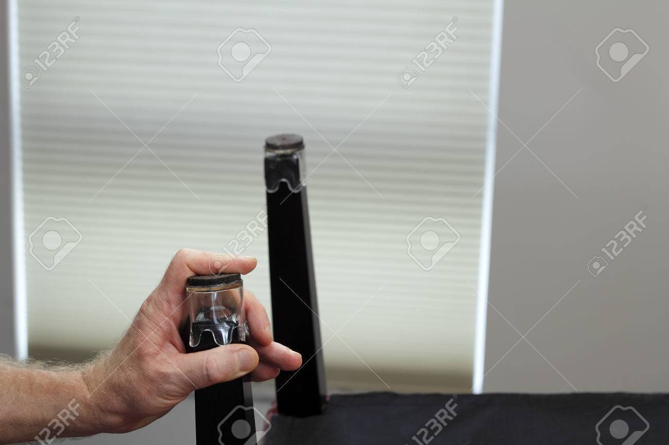 One Hand Installing One Clear Plastic And Felt Chair Floor