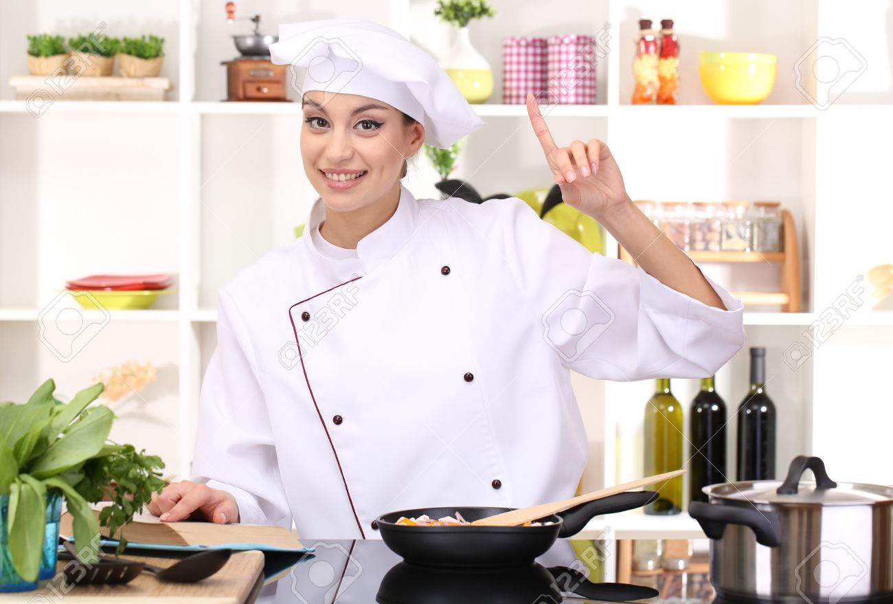 young woman chef cooking in kitchen stock photo picture and royalty