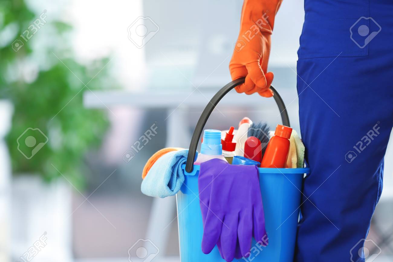 holding cleaning products and tools on bucket, close up - 106018599 holding cleaning products and tools on bucket, close up - 106018599