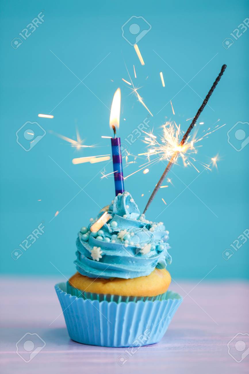 Birthday Cupcake With Candle And Sparkler On Color Background Stock Photo Picture And Royalty Free Image Image