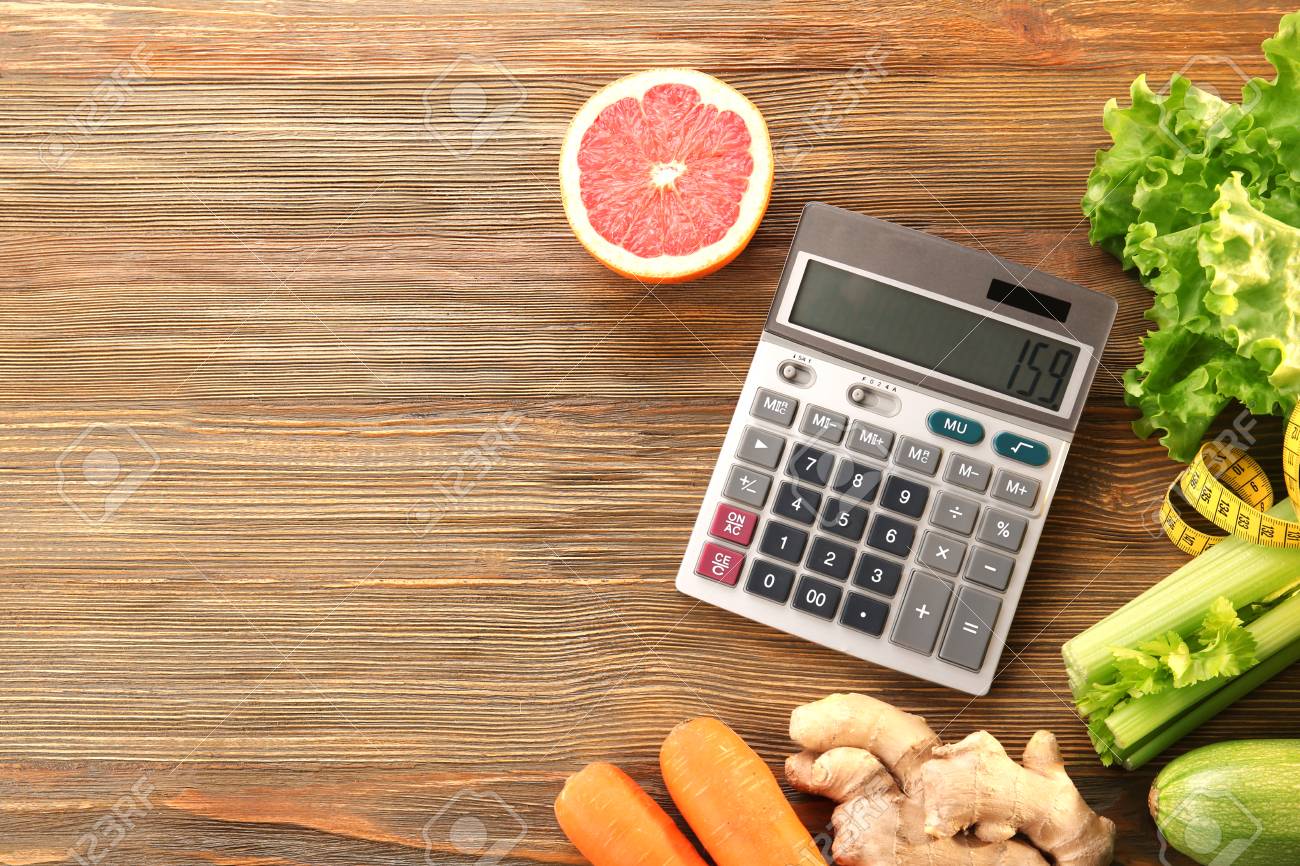 diet concept calculator measuring tape and different groceries