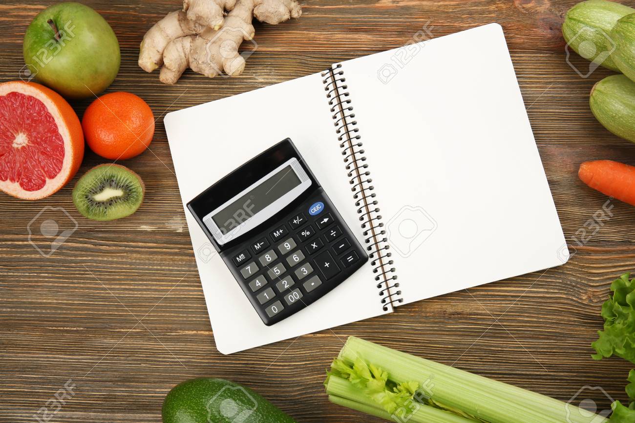 diet concept calculator notebook and different groceries on