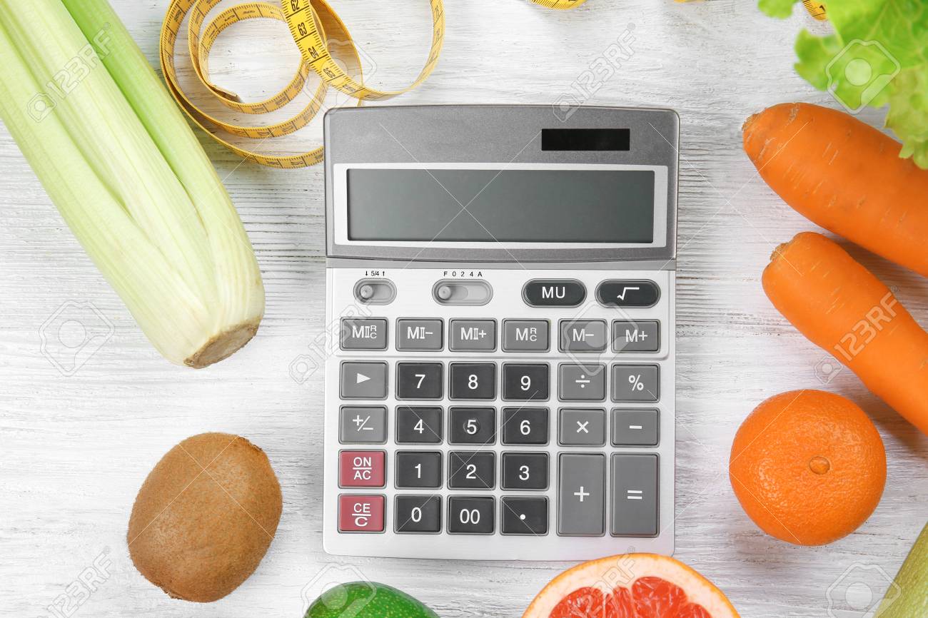 diet concept calculator measuring tape and different groceries