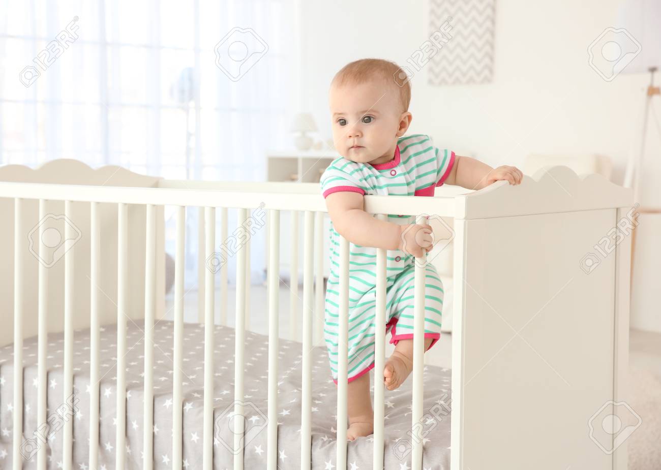 Cute Little Baby Standing In Crib At Home Stock Photo Picture And Royalty Free Image Image 111206080