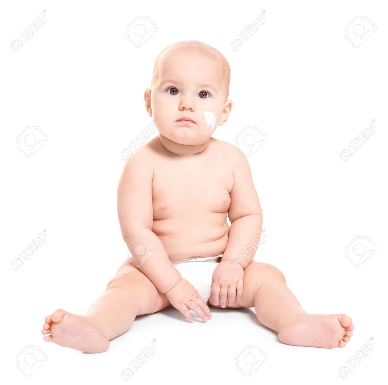 Cute baby with body cream on cheek against white background - 115198558 Cute baby with body cream on cheek against white background - 115198558