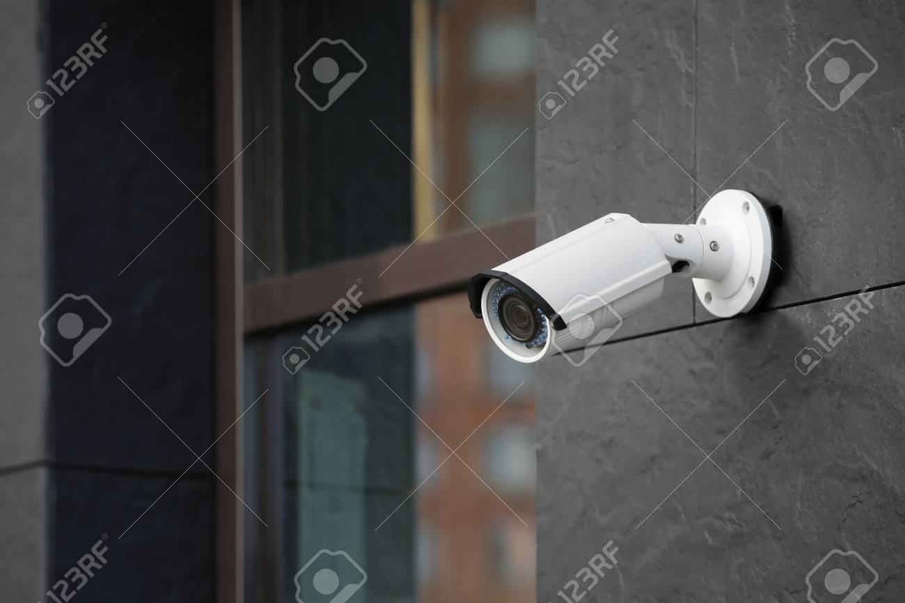 Modern CCTV camera on wall of building outdoors - 112787149 Modern CCTV camera on wall of building outdoors - 112787149