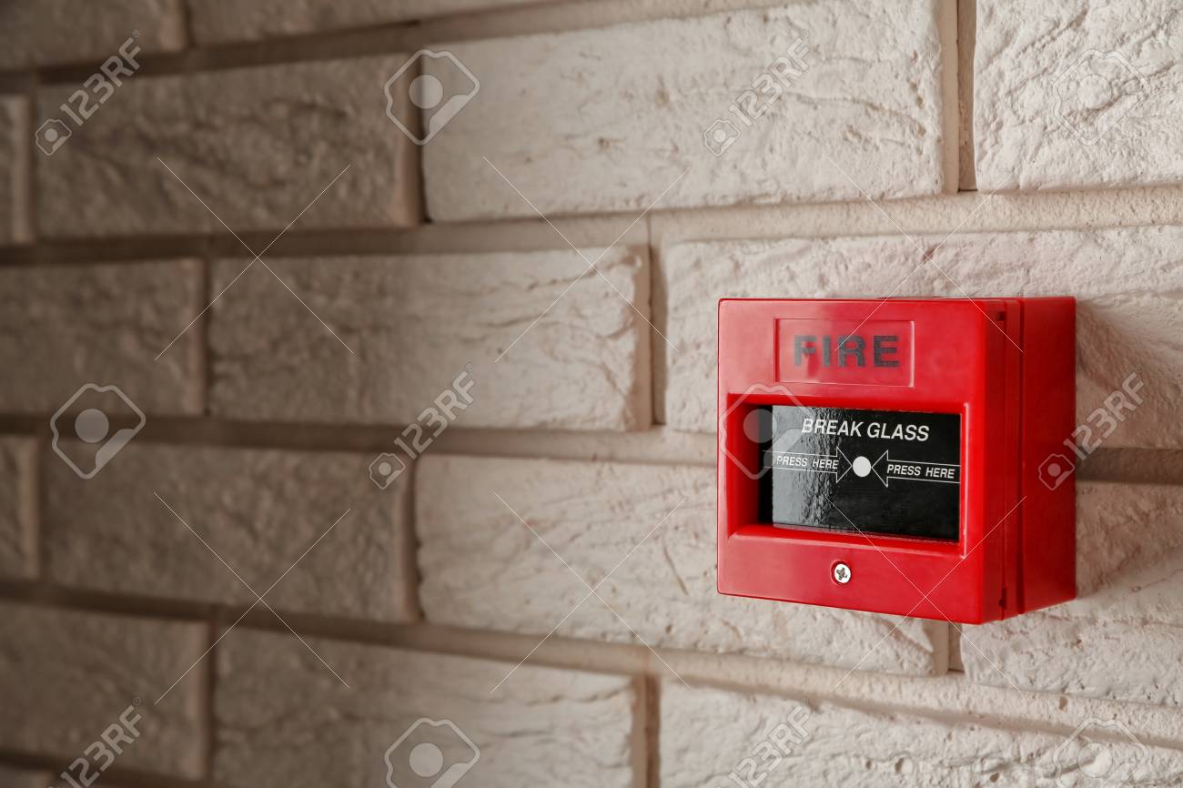 Modern fire call point on brick wall indoors - 114692111 Modern fire call point on brick wall indoors - 114692111