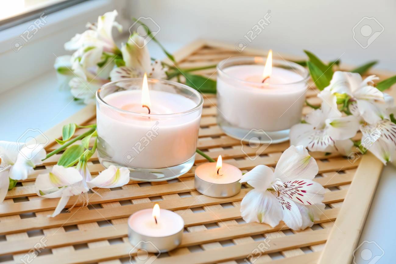 Burning Wax Candles With Flowers On Windowsill Stock Photo Picture And Royalty Free Image Image 113577943