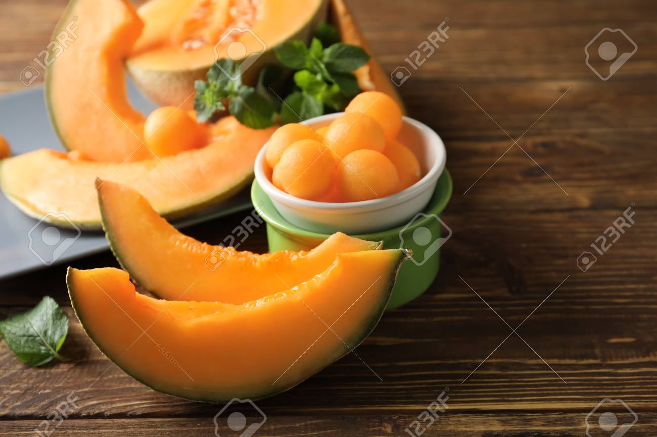 Cut ripe melon and balls on wooden table - 116089526 Cut ripe melon and balls on wooden table - 116089526