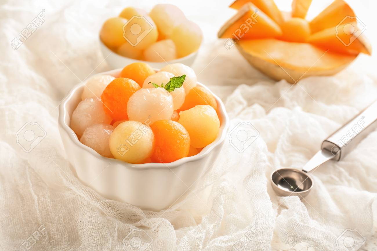 Bowl with delicious melon balls on table - 114764304 Bowl with delicious melon balls on table - 114764304