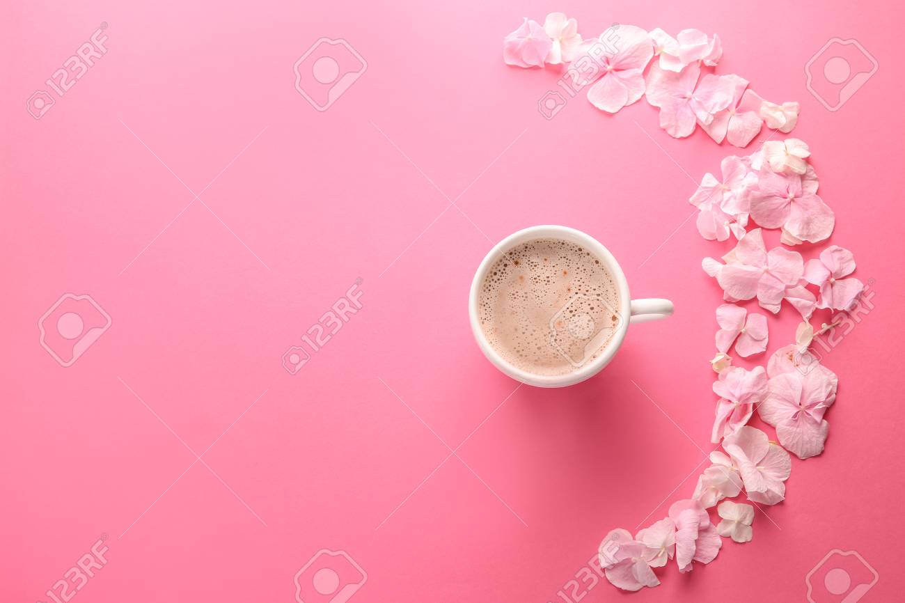 Beautiful flowers and cup of coffee on pink background - 115231544 Beautiful flowers and cup of coffee on pink background - 115231544