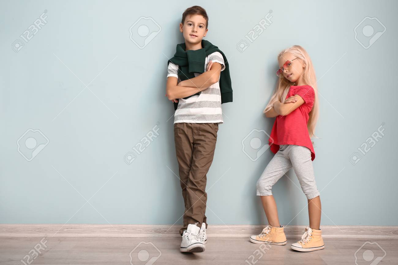 Cute boy and girl in fashionable clothes near color wall - 115307666 Cute boy and girl in fashionable clothes near color wall - 115307666