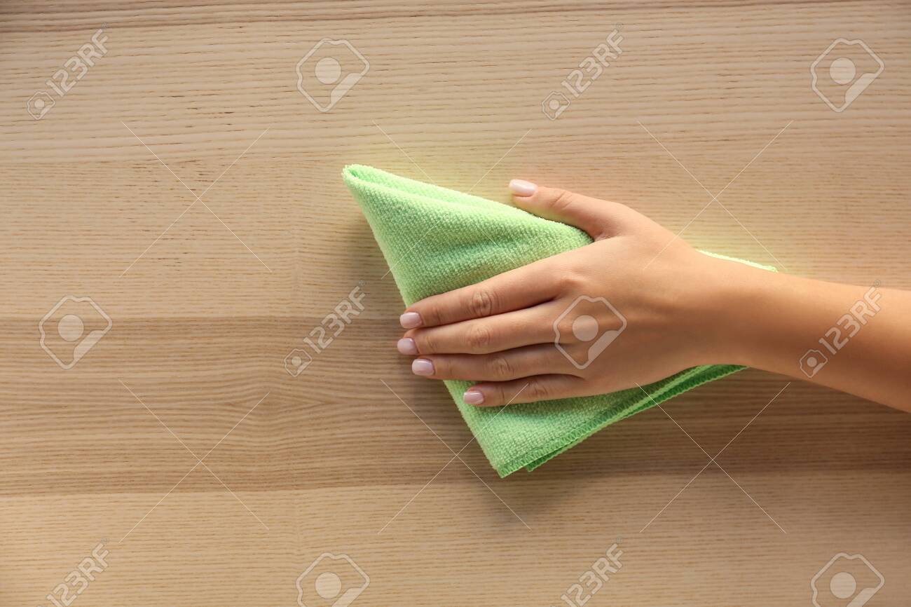 Woman cleaning wooden surface, top view - 115326533 Woman cleaning wooden surface, top view - 115326533