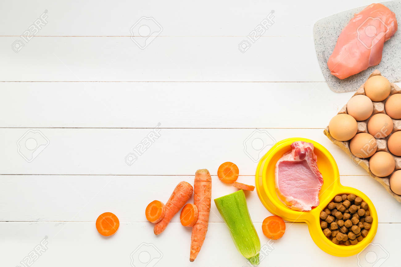 Composition with dry pet food and natural products on wooden background - 166030824 Composition with dry pet food and natural products on wooden background - 166030824
