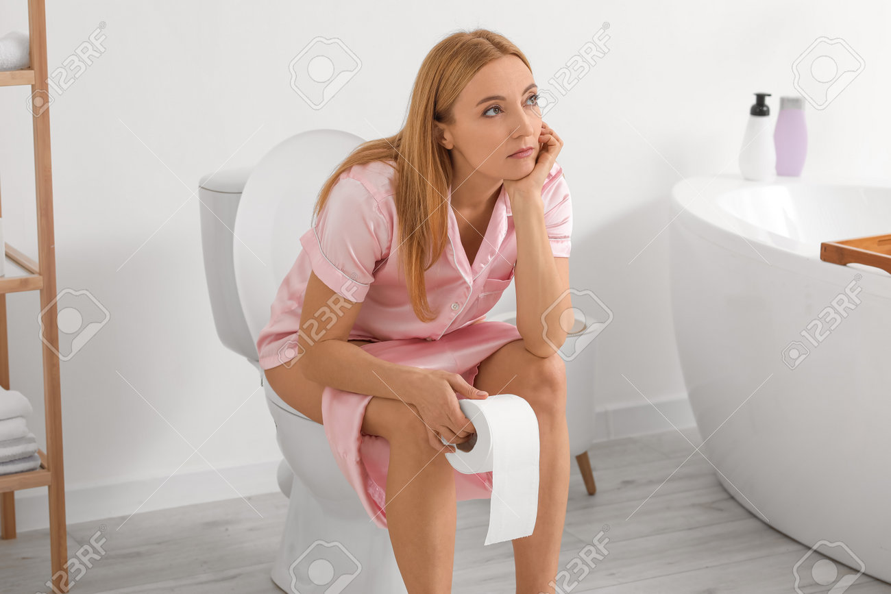 Mature Woman Sitting On Toilet Bowl In Bathroom Stock Photo, Picture and  Royalty Free Image. Image 192655329., image size:1300x867
