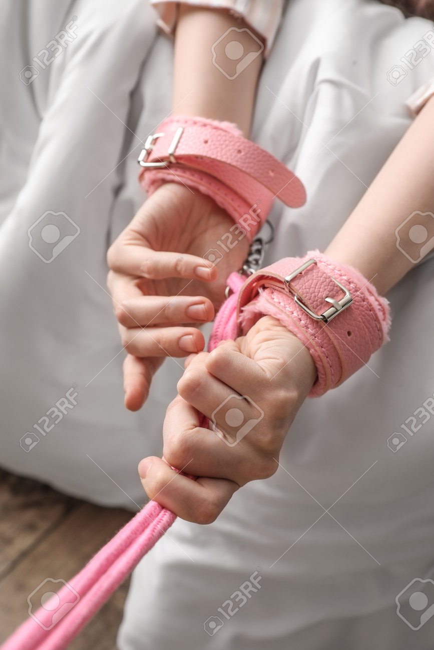Woman With Handcuffs From Sex Shop On Bed Closeup Stock Photo  