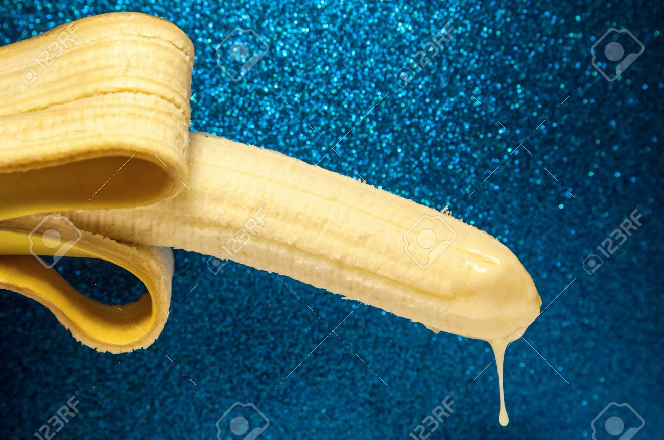 116773553-condensed-milk-drips-from-the-end-of-a-banana-on-shiny-blue-background-the-concept-of-ejaculation-em.jpg