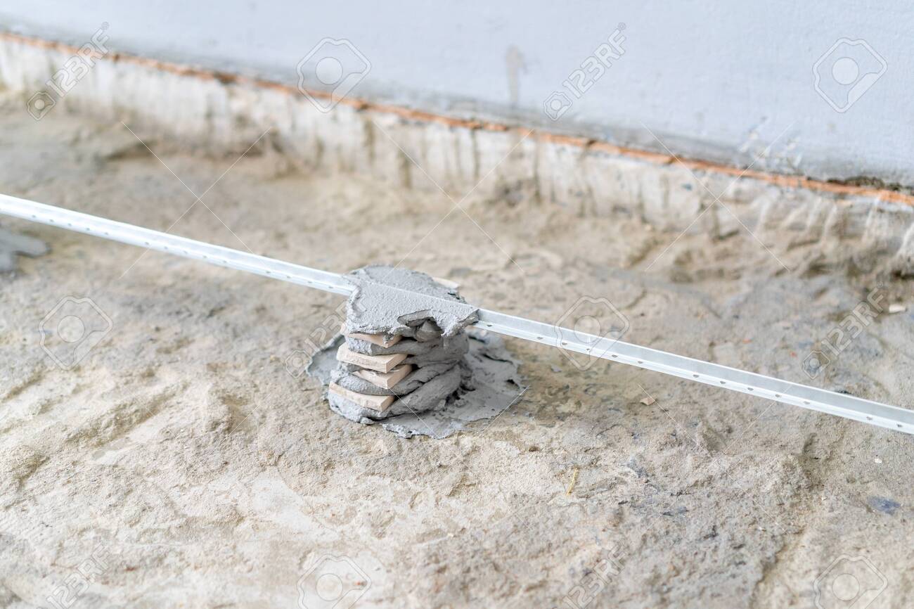 Installation Of A Guide For Concrete Screed Repair And Rough Finishing In The Apartment Floor Repair Installation Of Guides For Concrete Screeds Stock Photo Picture And Royalty Free Image Image 147262446