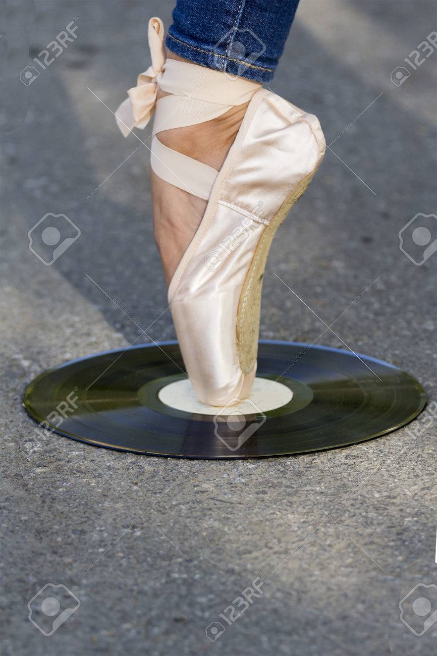 バレエ シューズで足の女の子は 道路上にあるビニール ディスクに立っています の写真素材 画像素材 Image
