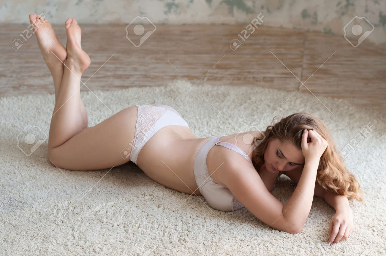 Curly Sexy Girl Plus Size Lingerie Is Lying On The Mat On His Stomach Legs Crossed Curly Sexy Girl Plus Size Lingerie Is Lying On The Mat On His Stomach Legs Crossed