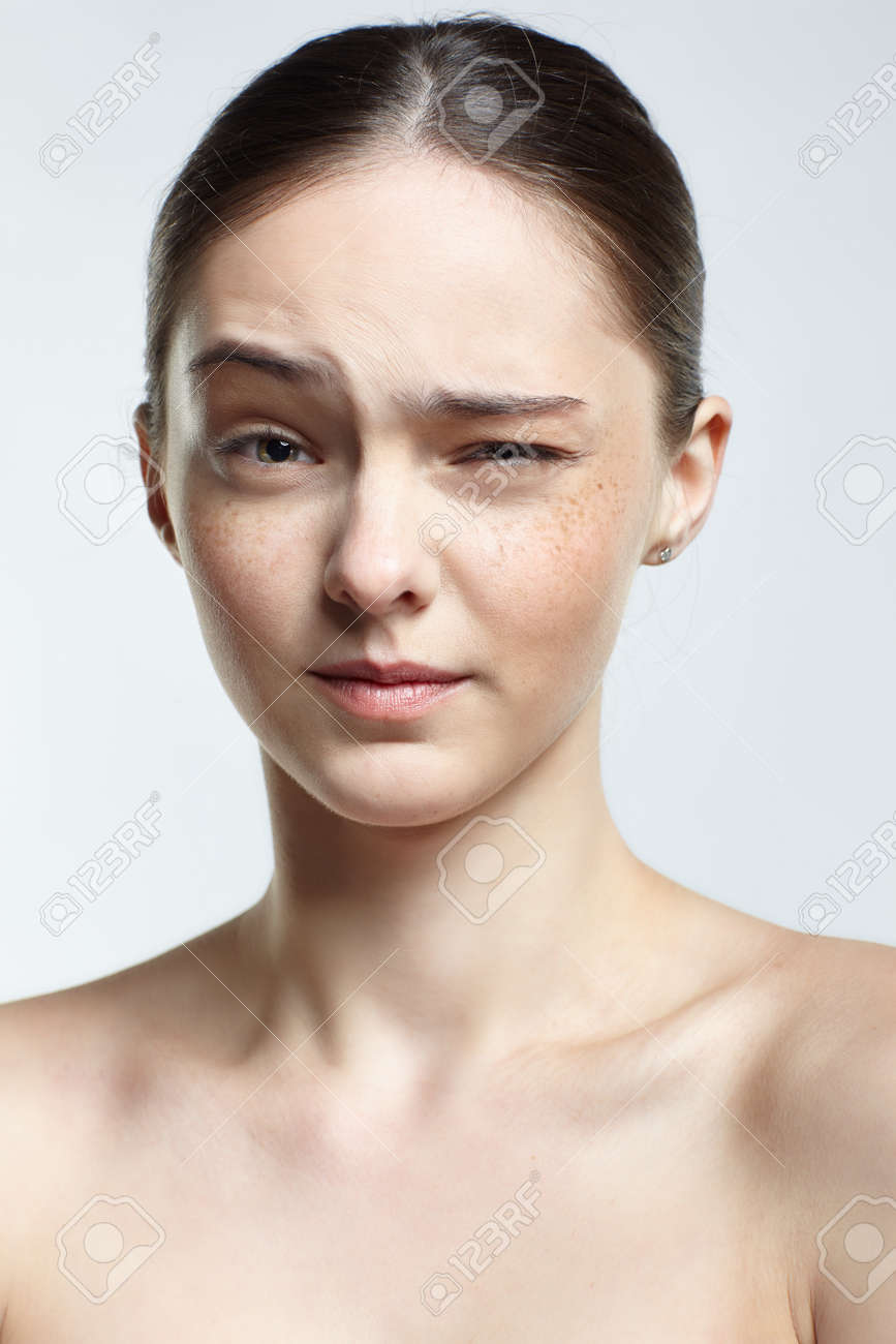 Emotional Young Woman Face Portrait With Wink. Human Female Natural  Emotions And Expressions Concept. Girl With Clean, Healthy Skin And Nude  Makeup Posing On White Background. Фотография, картинки, изображения и  сток-фотография без