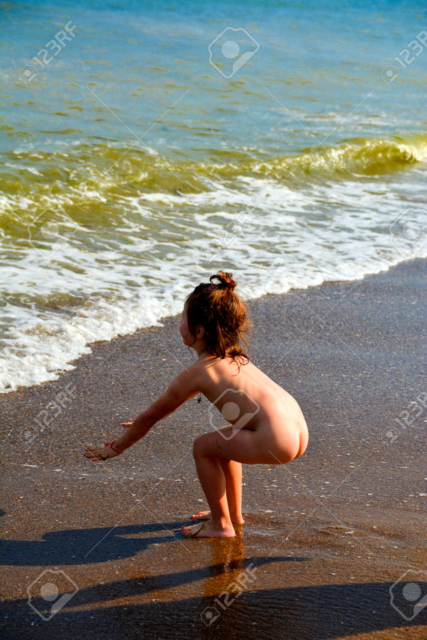 Naked Child On The Sea Beach Playing With Sand And Waves Stock Naked Child On The Sea Beach Playing With Sand And Waves Stock