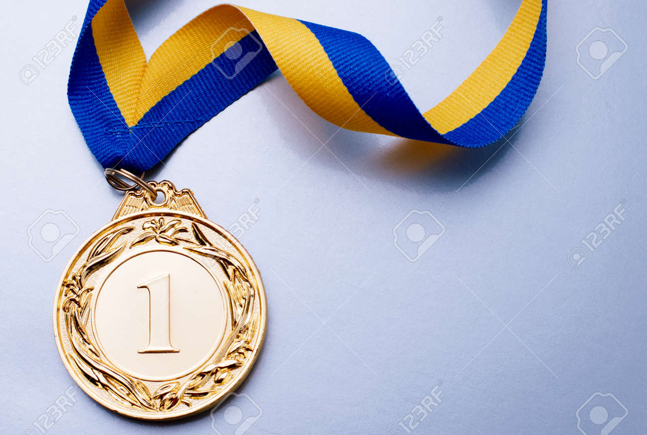 Gold medal in the foreground on yellow blue ribbon - 36510608 Gold medal in the foreground on yellow blue ribbon - 36510608