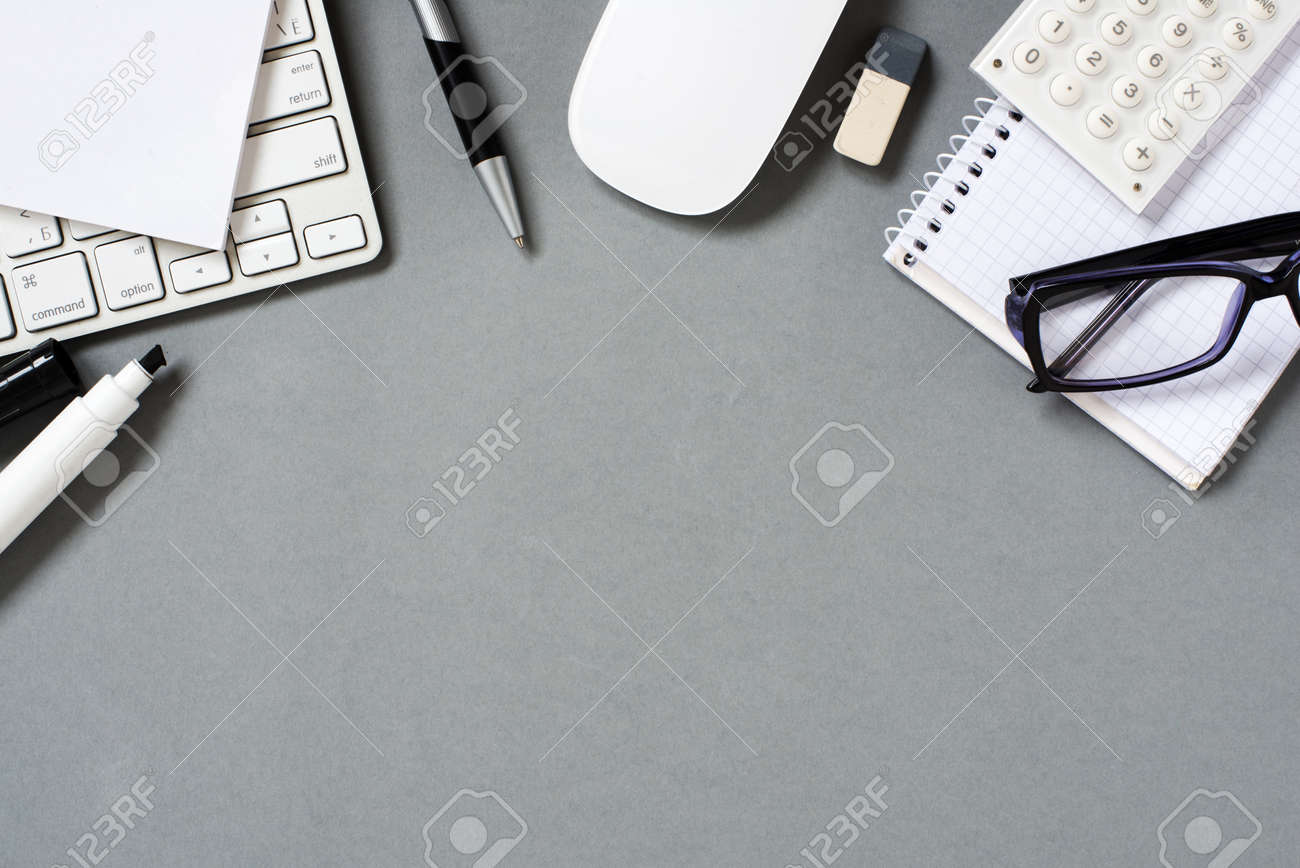 High Angle View of Mac Computer Keyboard and Mouse with Various Office Supplies and Eyeglasses Scattered on Grey Desk with Ample Copy Space - 40628496 High Angle View of Mac Computer Keyboard and Mouse with Various Office Supplies and Eyeglasses Scattered on Grey Desk with Ample Copy Space - 40628496