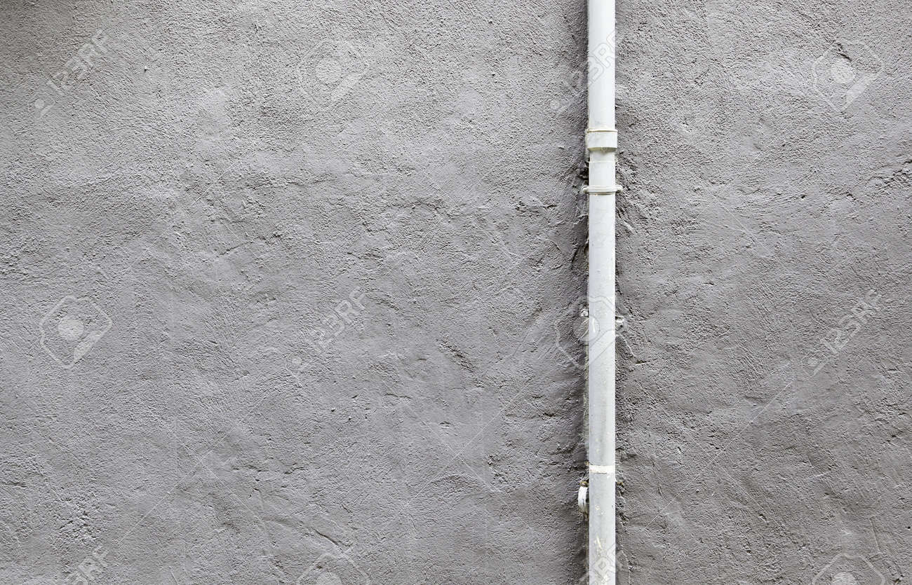pipe cement wall detail of a wall painted with a metal pipe