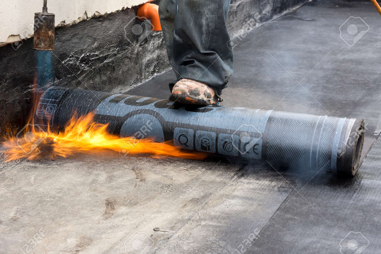 Worker Burning While The Waterproof Membrane On A Roof Stock Photo, Picture  and Royalty Free Image. Image 66900563.