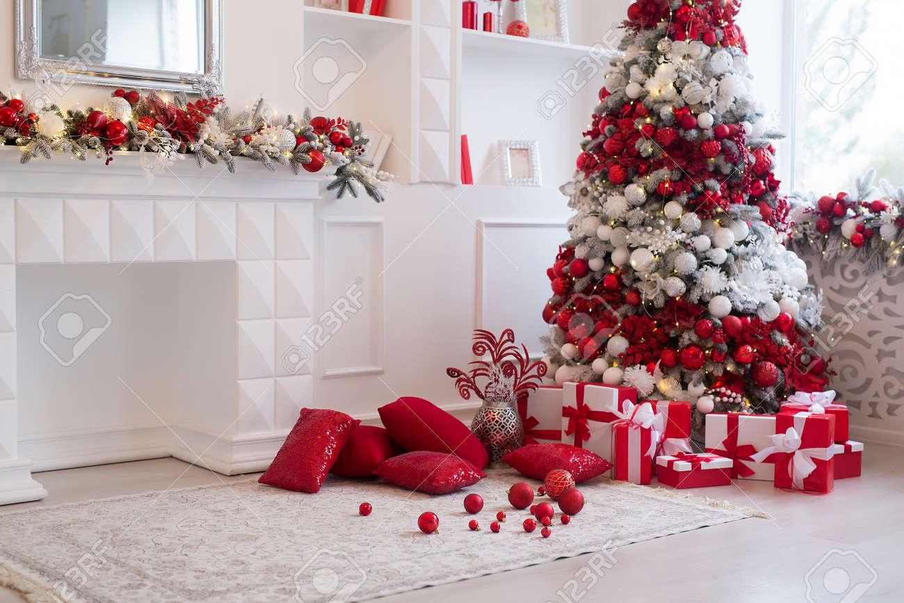 Interior of bright modern living room with fireplace decorated with Christmas tree and gifts - 158639718 Interior of bright modern living room with fireplace decorated with Christmas tree and gifts - 158639718