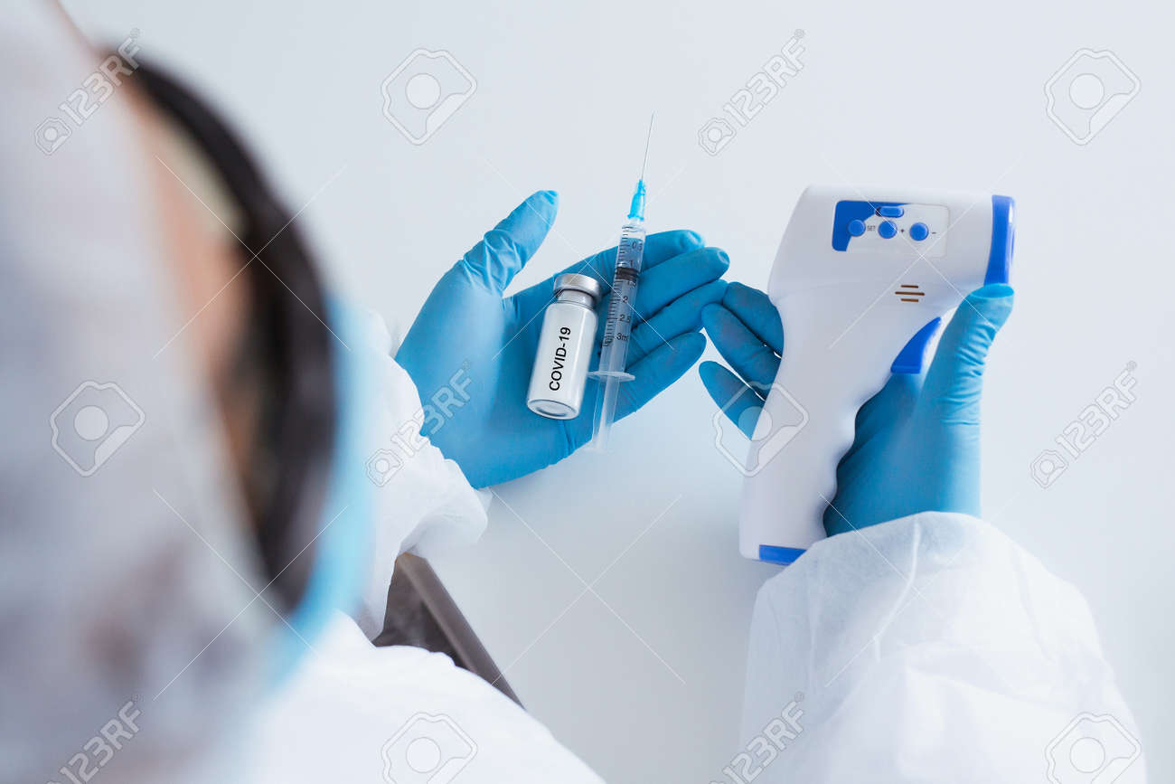 COVID vaccine. Competent medical worker spending his work time in the laboratory while researching coronavirus disease - 158700653 COVID vaccine. Competent medical worker spending his work time in the laboratory while researching coronavirus disease - 158700653
