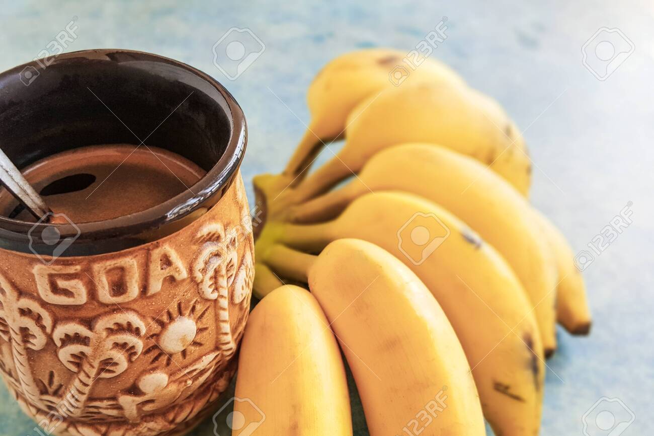 Ceramic Goa Coffee Mug And Bunch Of Yellow Bananas On A Blue Stock Photo Picture And Royalty Free Image Image 132071533