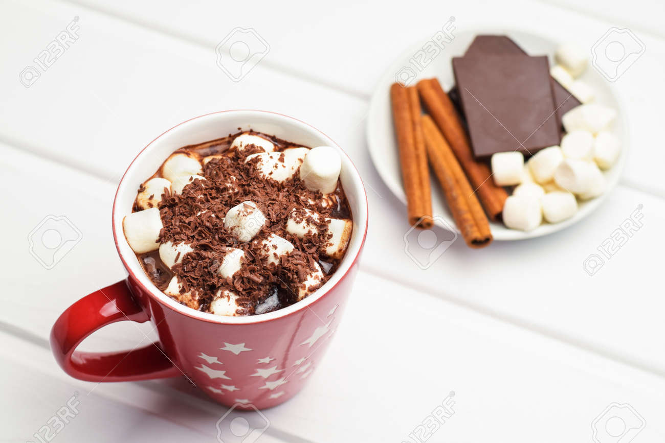 Cocoa in a red mug and ingredients. - 113828153 Cocoa in a red mug and ingredients. - 113828153