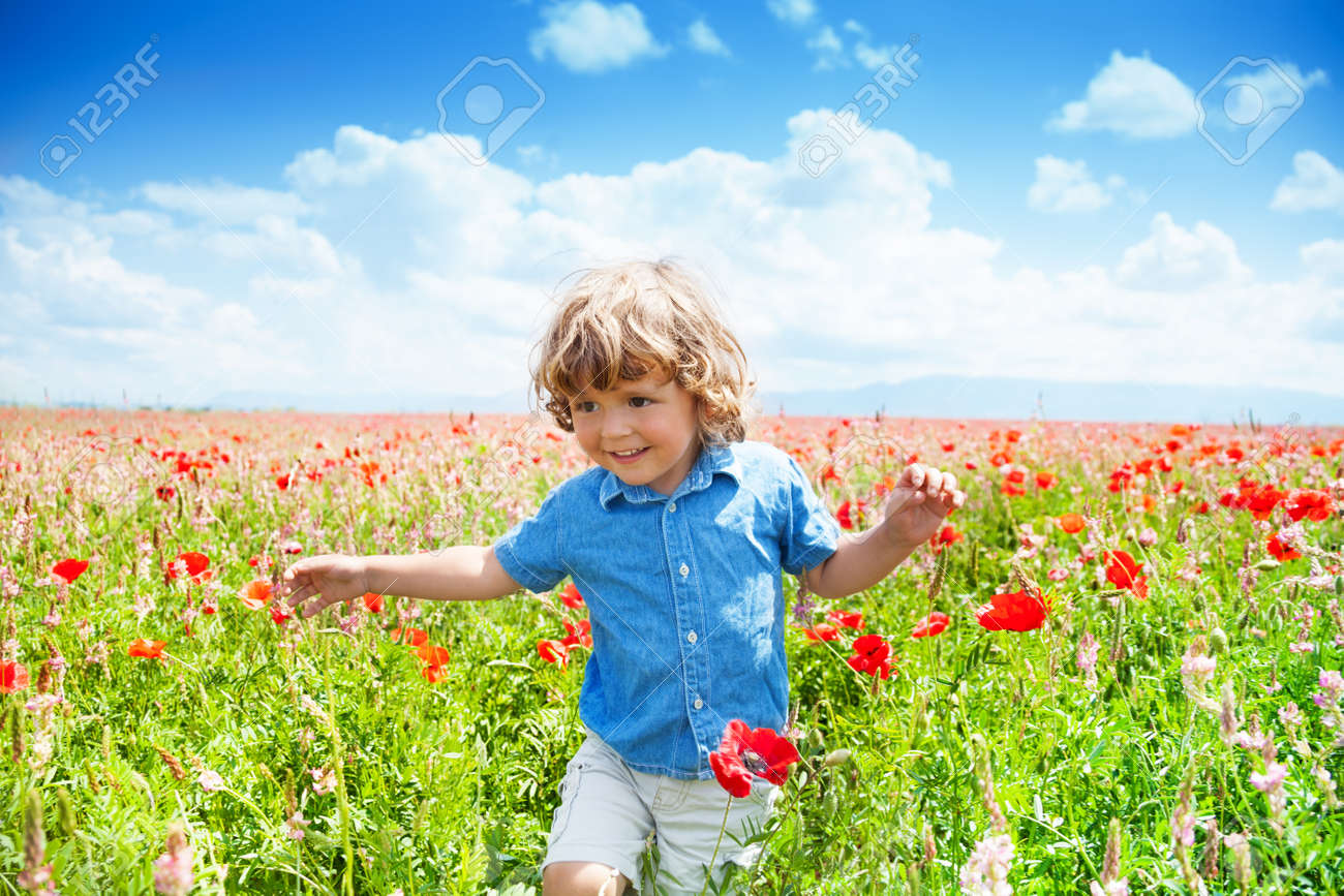 Happy Little Boy In Blue Short Running In Poppy Red Flowers Field Stock Photo Picture And Royalty Free Image Image