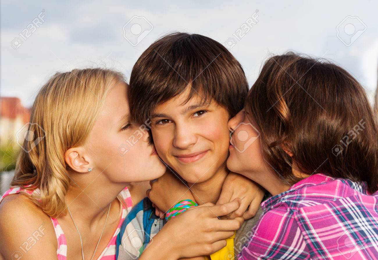 http://previews.123rf.com/images/serrnovik/serrnovik1410/serrnovik141000155/32782122-Two-girls-kiss-a-boy-in-cheeks-close-up-view-Stock-Photo.jpg
