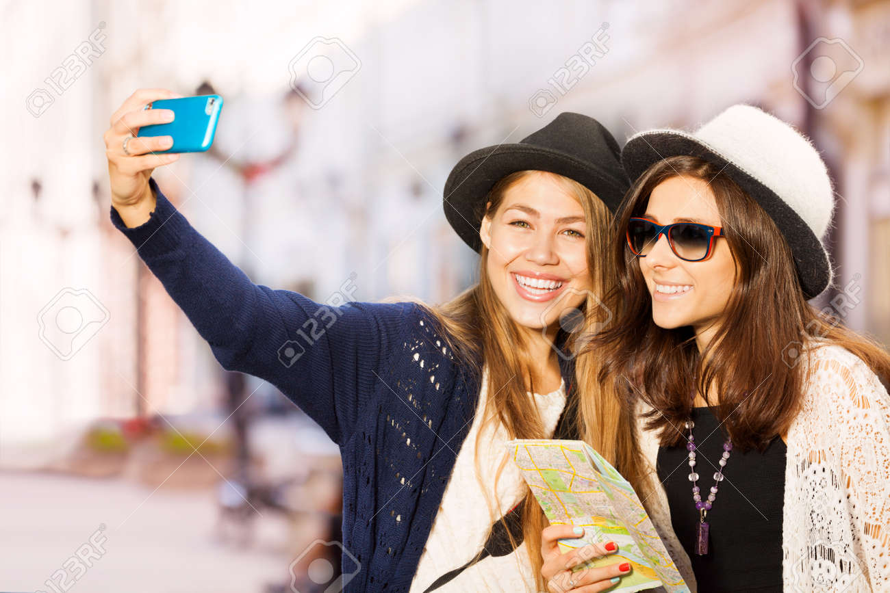 2 つのかわいい女の子の間の通りヨーロッパの観光中に携帯電話で Selfies を取って夏の日の時間 の写真素材 画像素材 Image 2 つのかわいい女の子の間の通りヨーロッパの観光中に携帯電話で Selfies を取って夏の日の時間 の写真素材 画像素材 Image