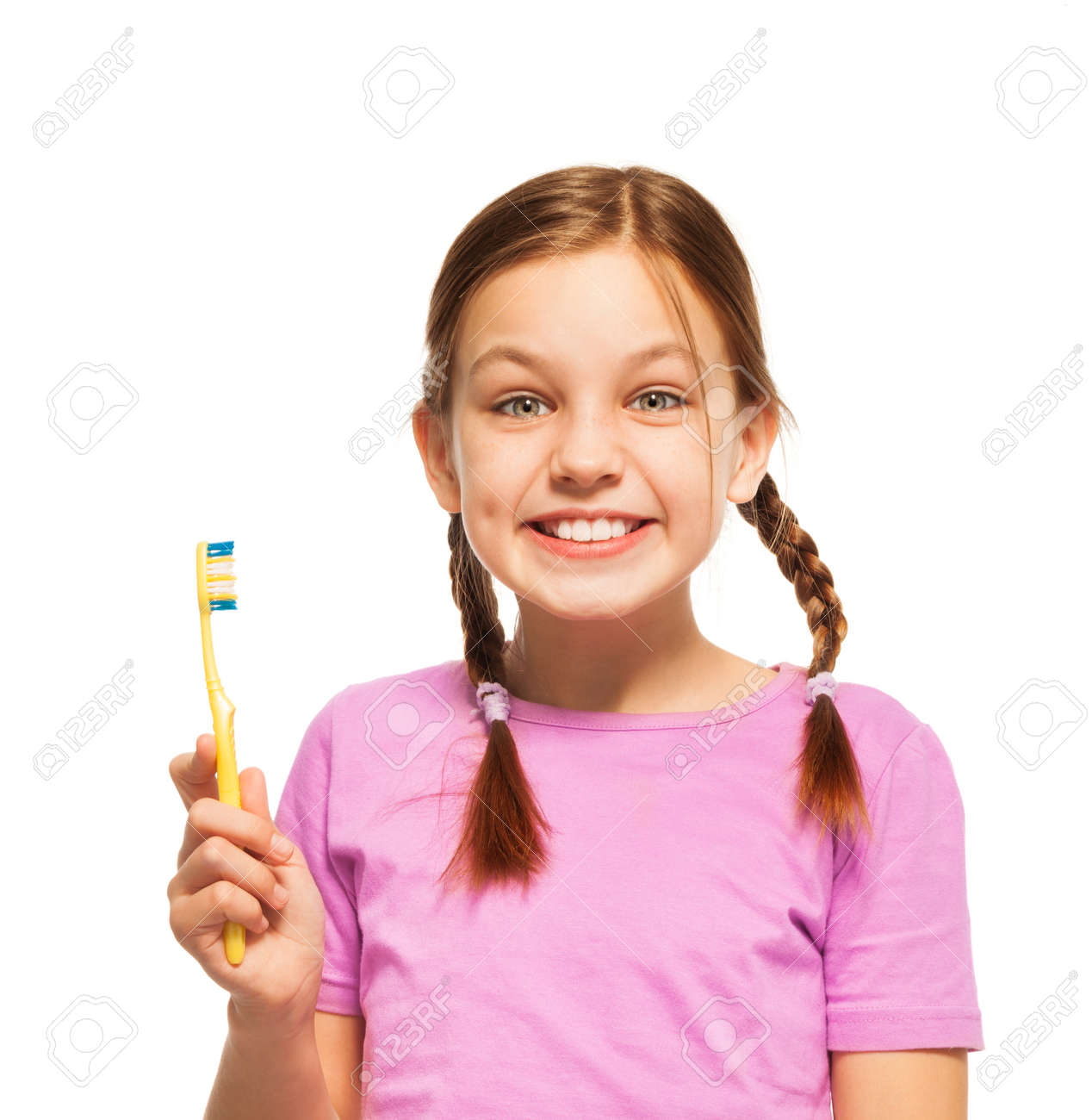 Happy smiling girl with healthy teeth holding yellow toothbrush in her hand isolated on white - 51621553 Happy smiling girl with healthy teeth holding yellow toothbrush in her hand isolated on white - 51621553