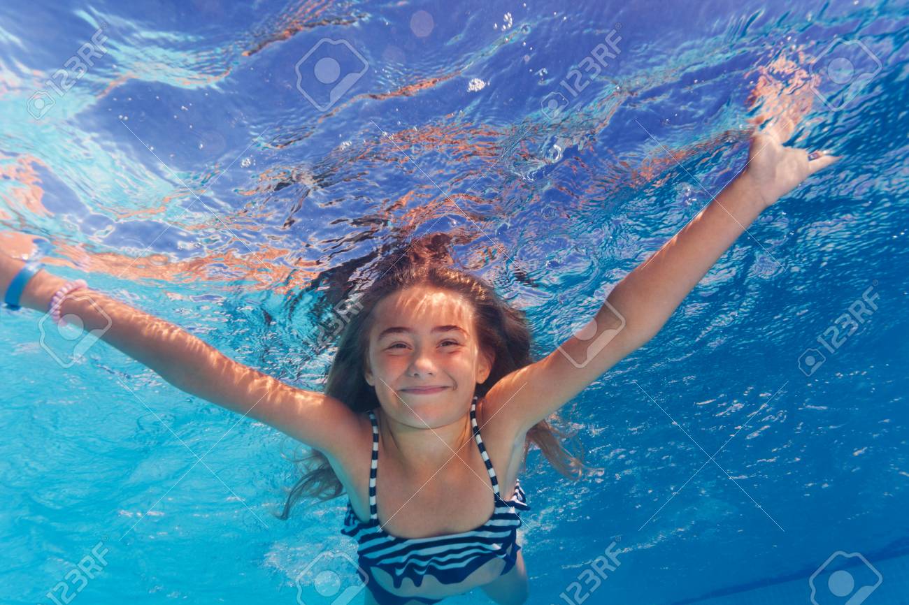 Beautiful preteen girl enjoying swimming under water of the pool - 106037073 Beautiful preteen girl enjoying swimming under water of the pool - 106037073