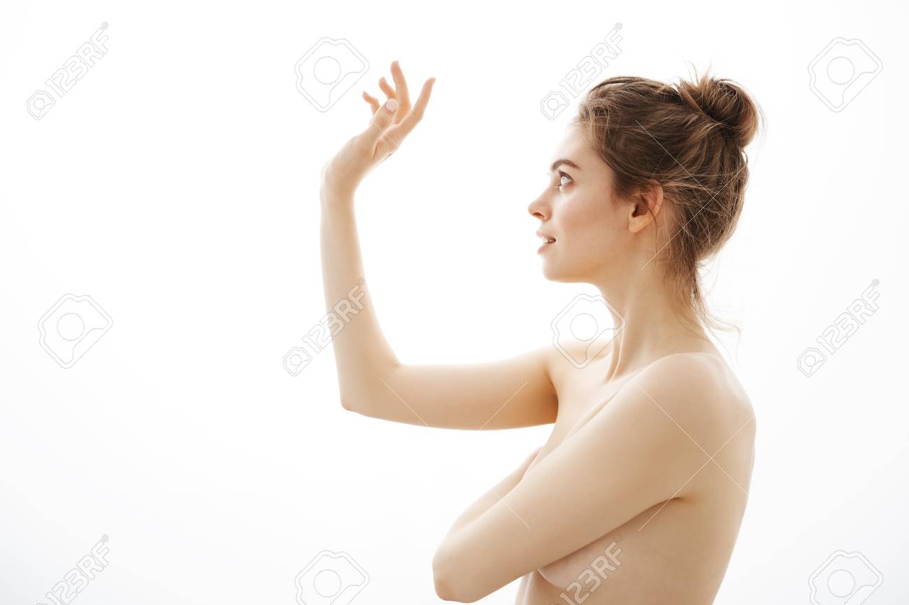 Portrait Of Young Beautiful Tender Naked Girl With Bun Posing In Profile Over White Background Portrait Of Young Beautiful Tender Naked Girl With Bun Posing In Profile Over White Background