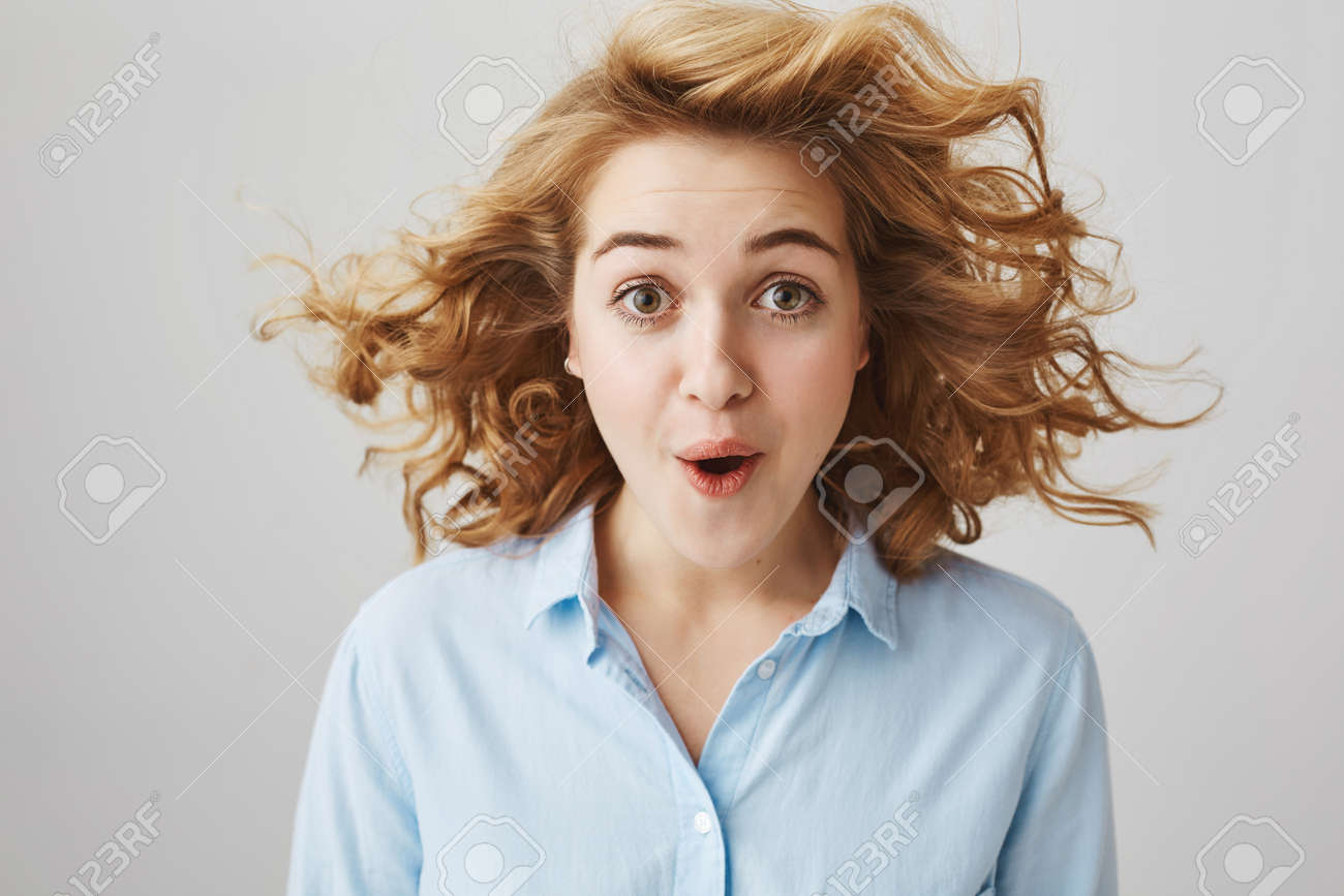 Indoor Shot Of Overwhelmed Excited And Surprised Woman With Short