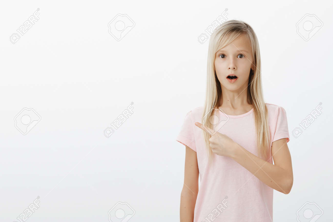 Indoor Shot Of Amazed Surprised Little Child With Fair Hair