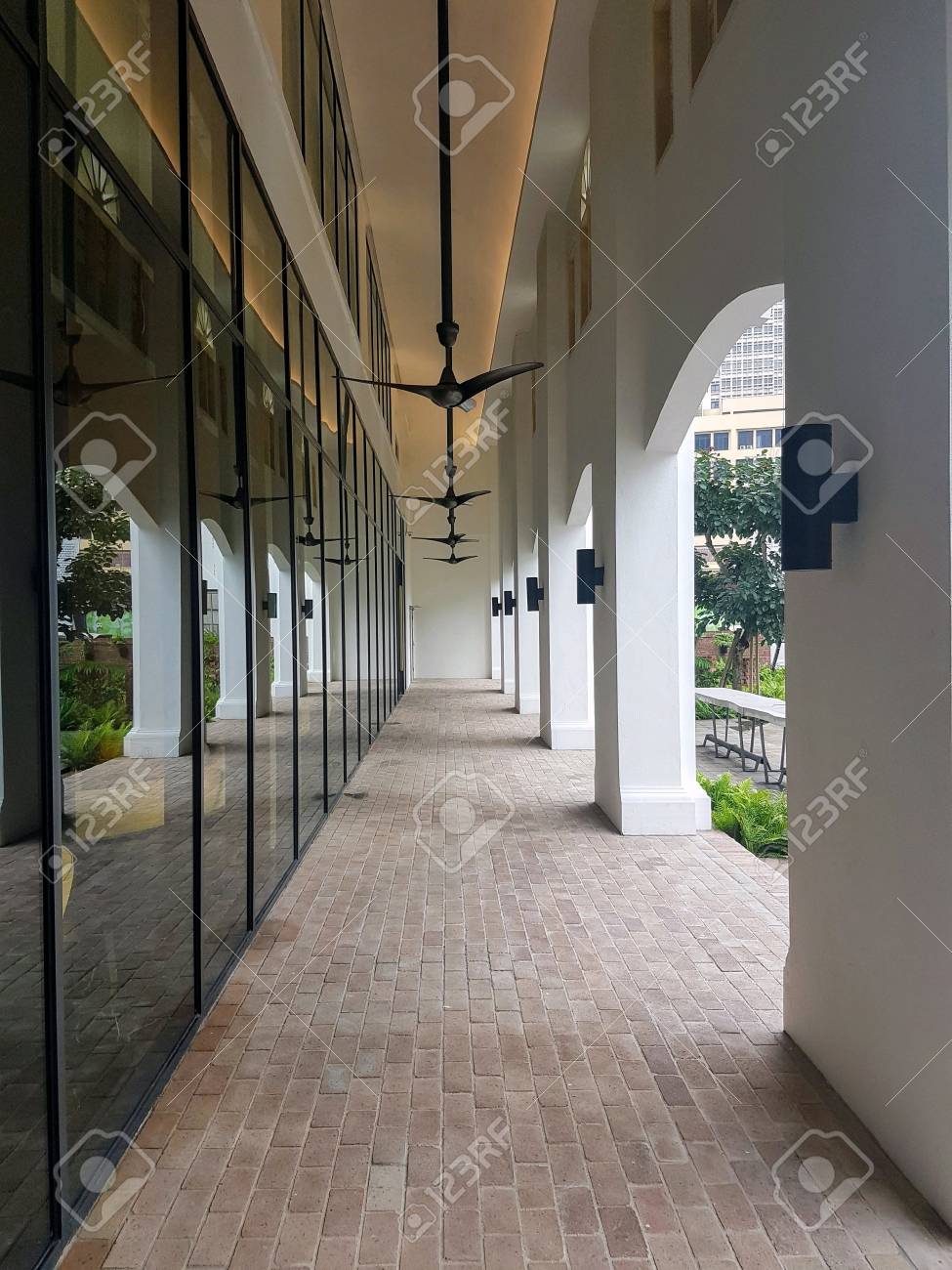 Walkway Outside A Restaurant With Ceiling Fans And White Columns