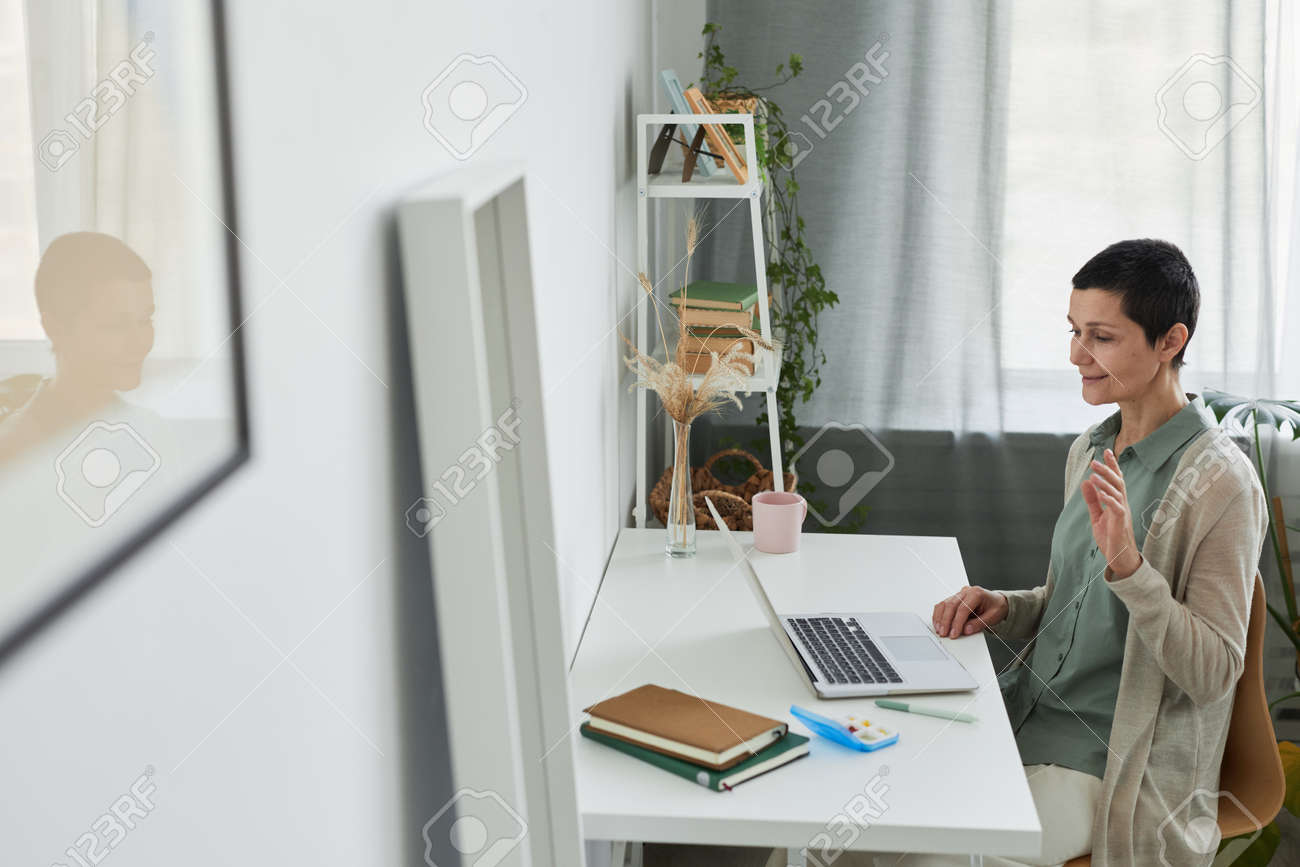 Smiling Mature Woman Waving Hello