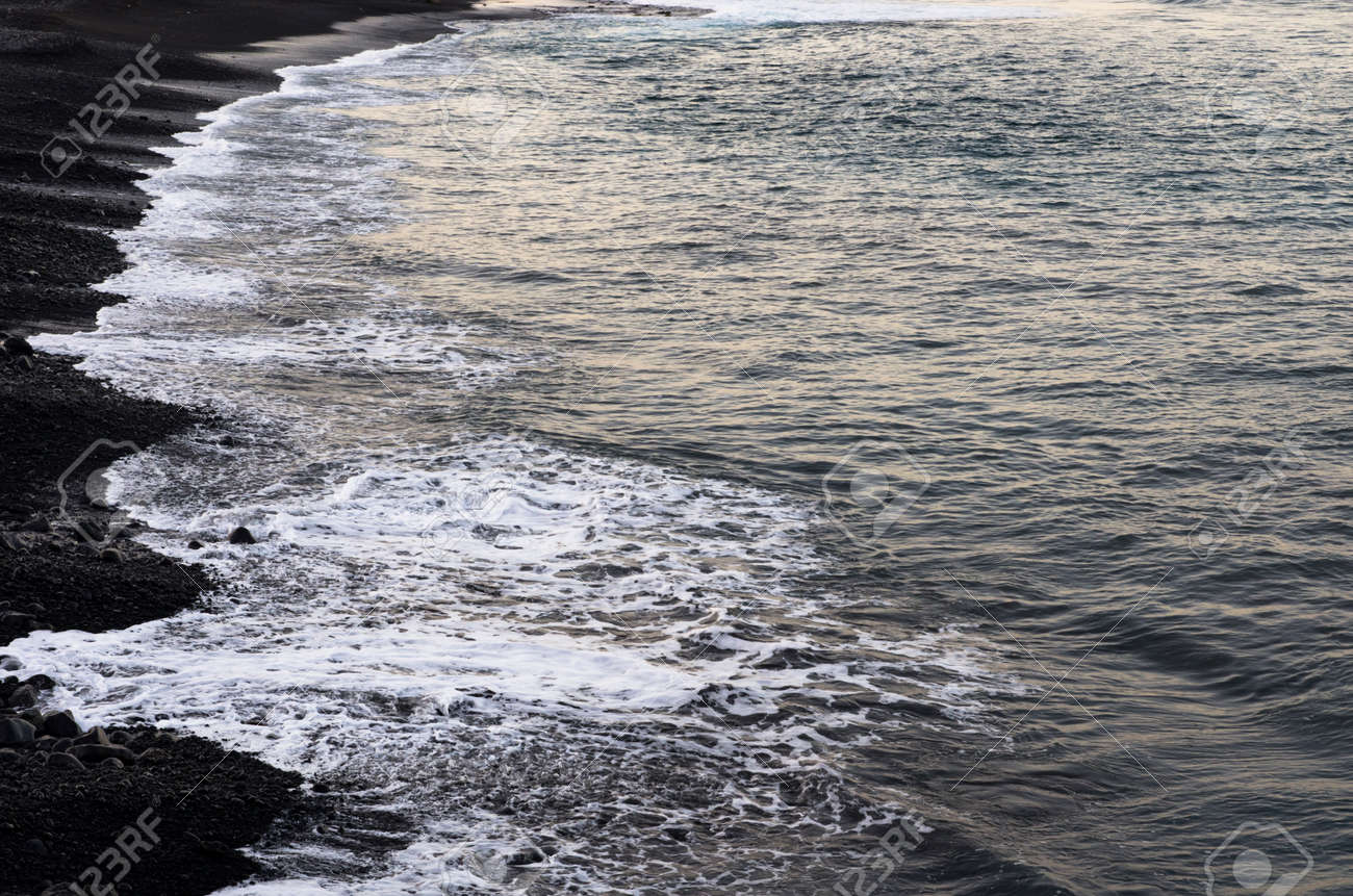 Sea surf rolls on a black beach - 137635179 Sea surf rolls on a black beach - 137635179