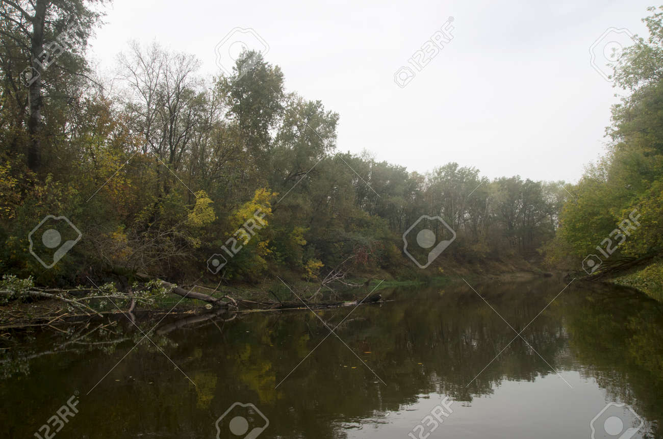 Landscape of an autumn river with trees on the bank - 159232225 Landscape of an autumn river with trees on the bank - 159232225