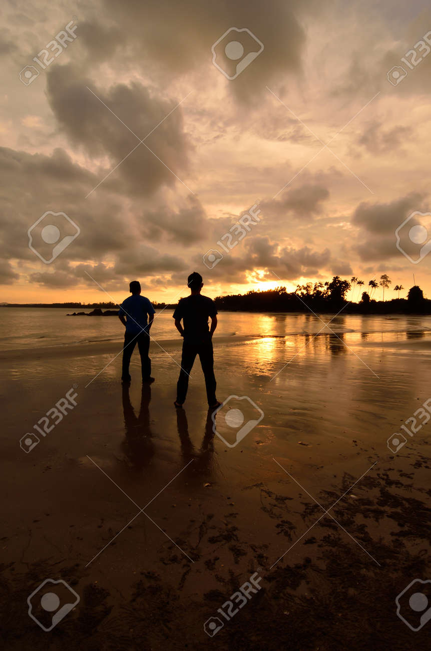 Two Friends Watching To The Sunset Near The Beach Stock Photo, Picture and  Royalty Free Image. Image 19157791., image size:861x1300